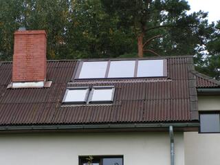 Solar collectors installed in the roof of a private house in Jaunciems